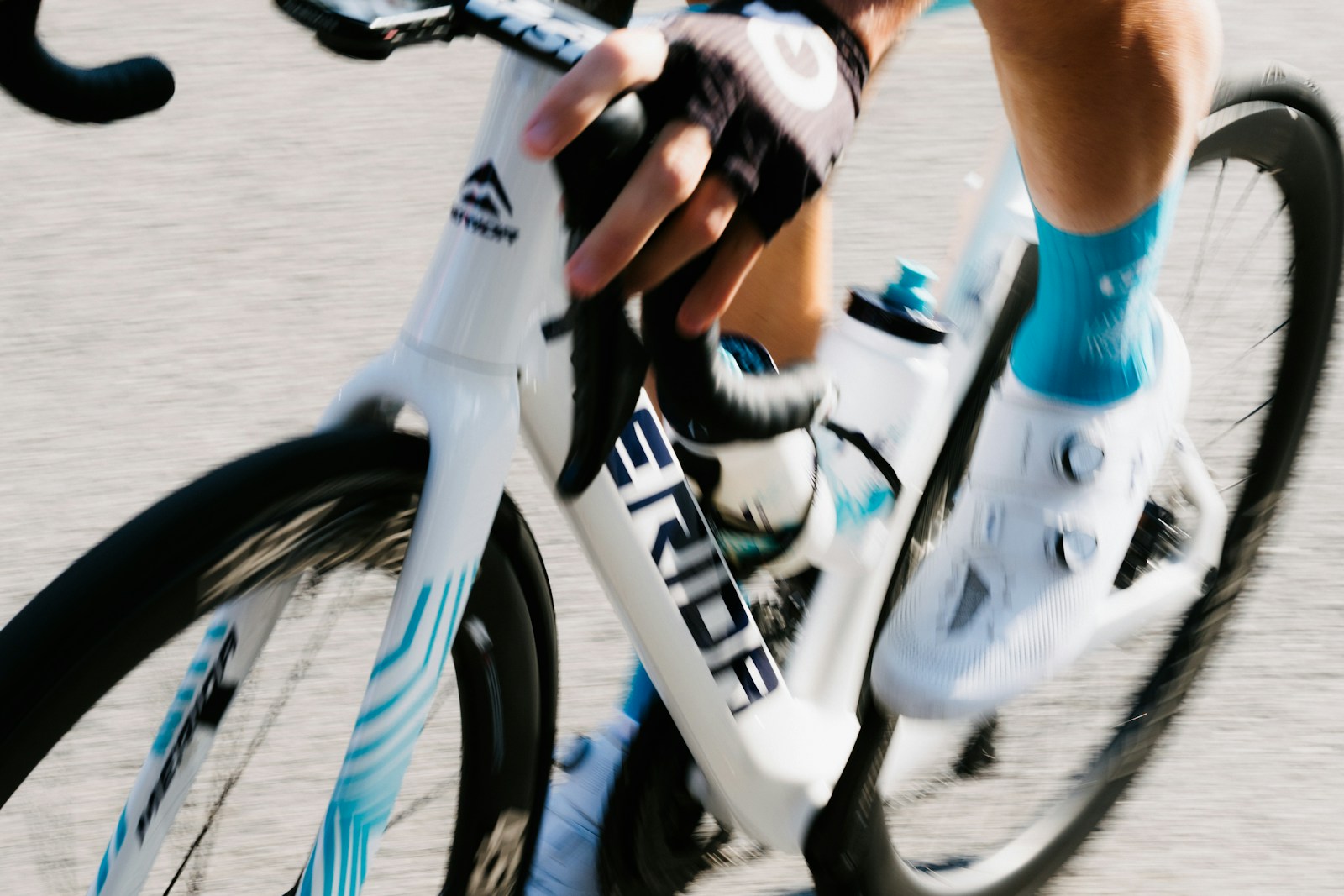 Cyclist drinking water mid-race to stay hydrated