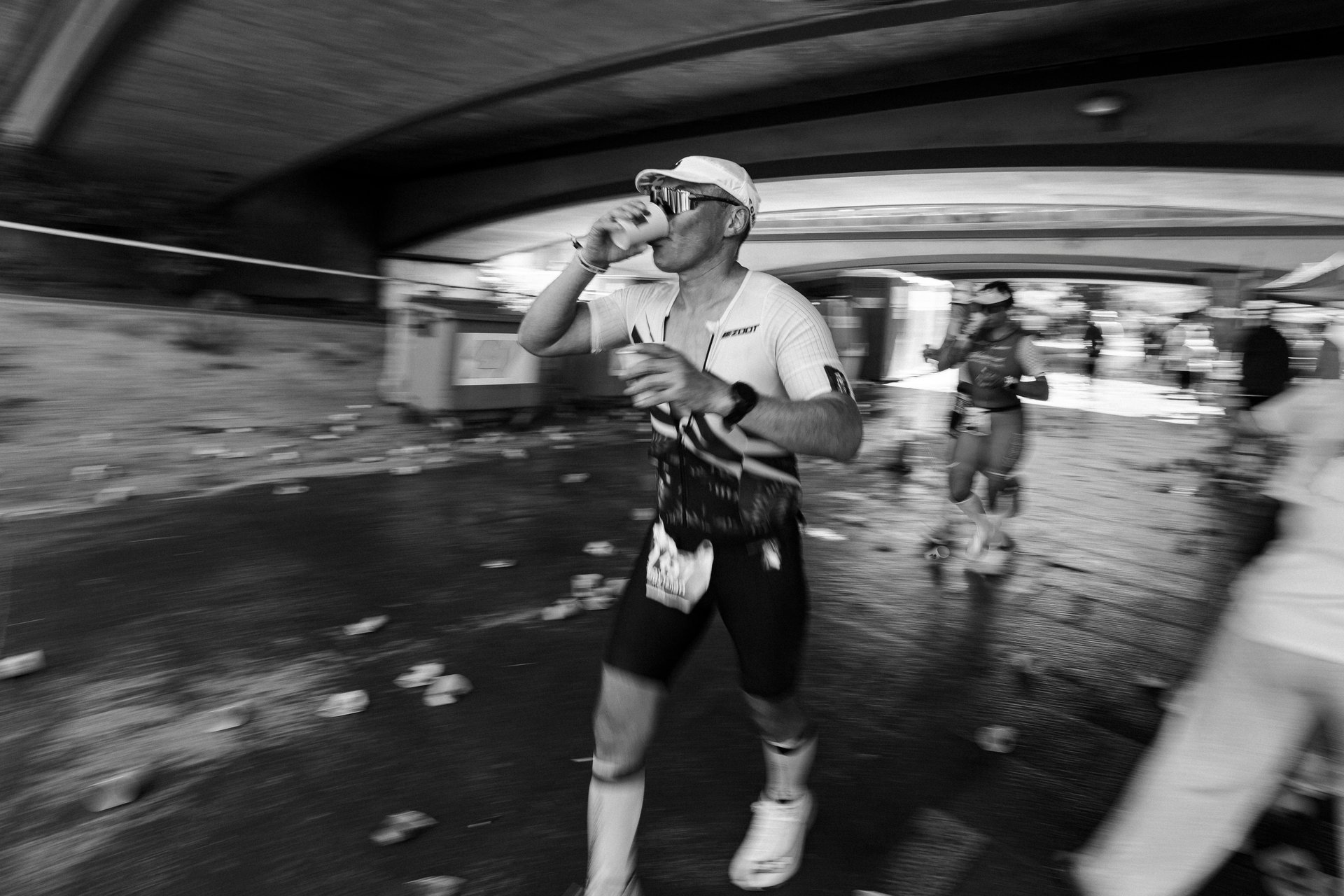 Endurance runner drinking from a cup during a race