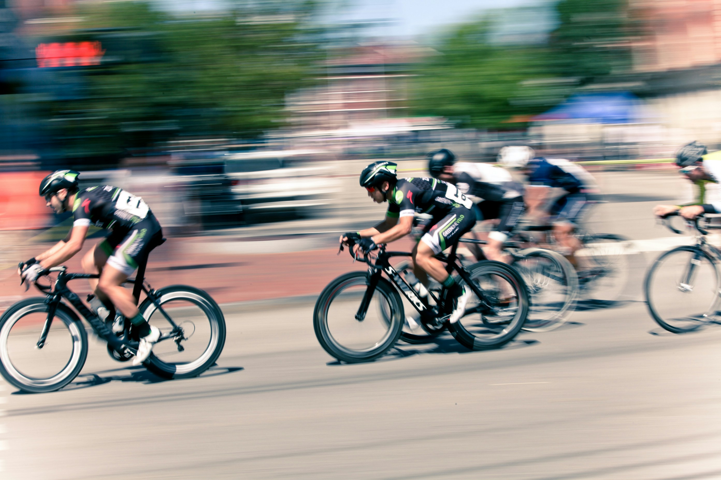 Road racers grouped in a paceline on an exposed US highway, illustrating drafting and pack tactics that conserve energy